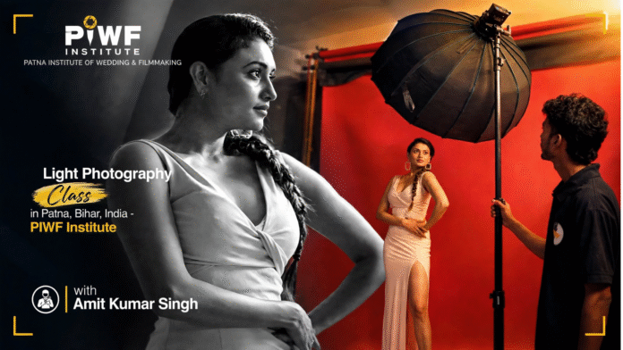 Light Photography Class in Patna, Bihar, India at PIWF Institute - Patna Institute of Wedding & Filmmaking with Amit Kumar Singh, student learning studio lighting setup with model in red backdrop